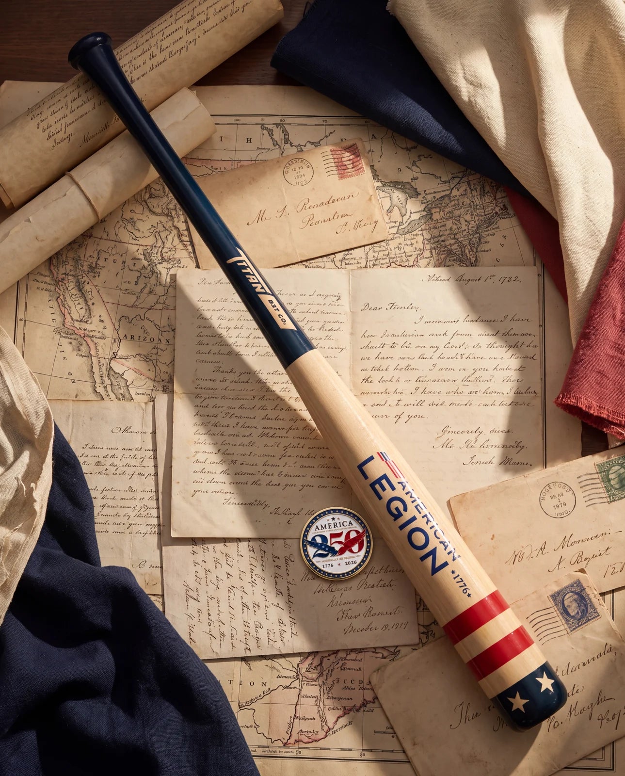 The anniversary bat, coin and American flag on a historic map